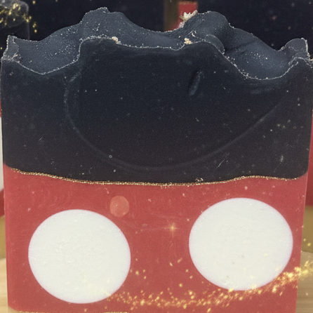 The Original handmade cold process soap bars with red polka dot layers and dark charcoal top against a whimsical magical background