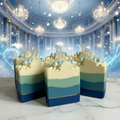 The Glass Slipper handmade cold process soap bars grouped on polished marble against an enchanted whimsical ballroom background